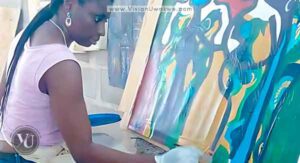 Vivian Uwakwe, Artist, painting on an easel